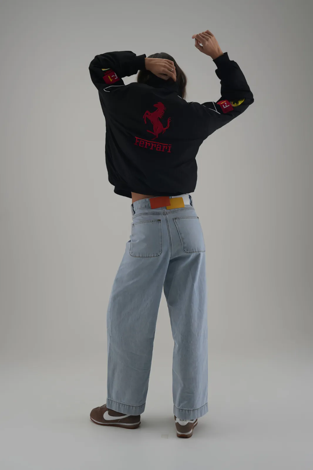 Back of Ferrari F1 Motorsport Jacket with stylish belt and wide-leg jeans