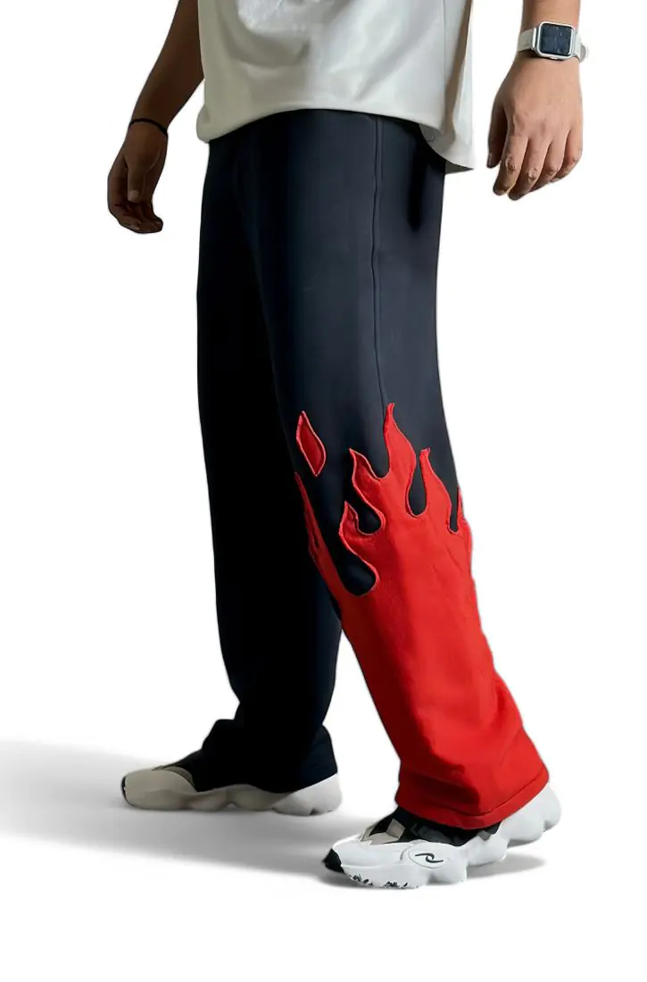 Model wearing The Drip Soul Red Fire Flame Kick Straight Baggy Track Pant – bold flame design with oversized streetwear fit.
