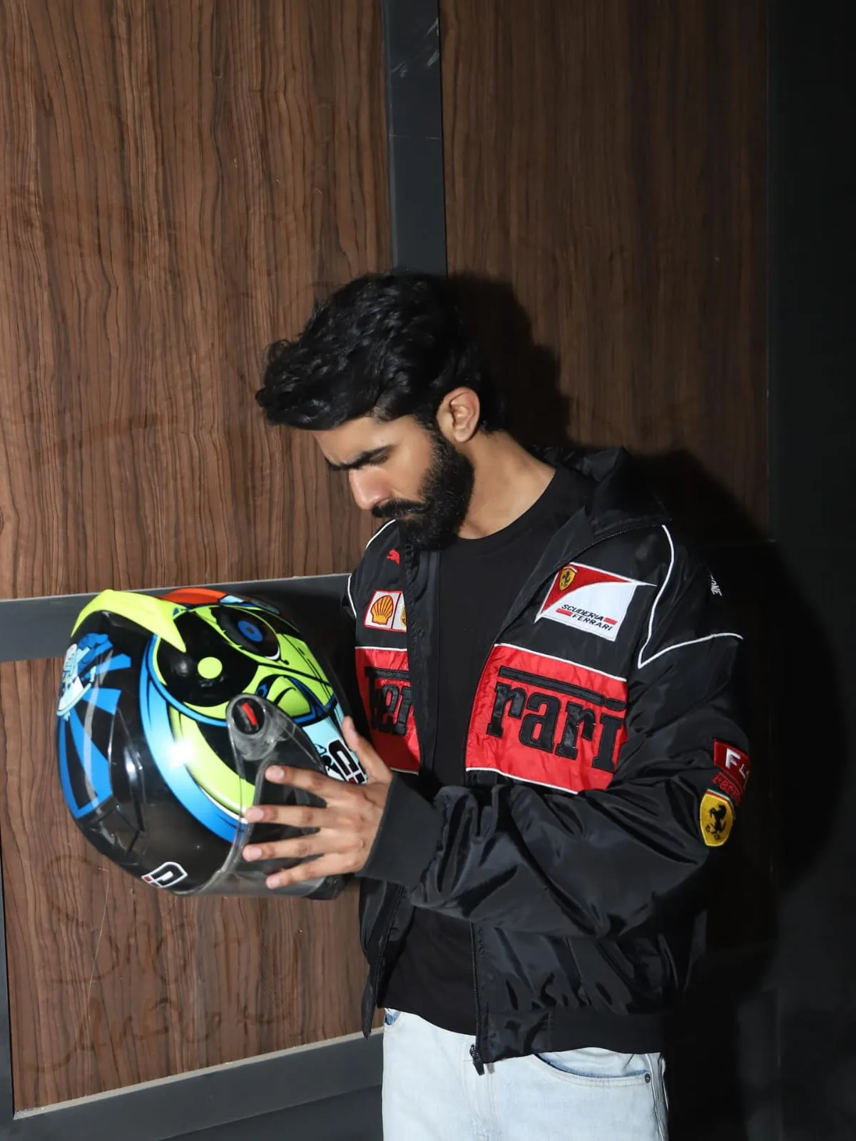 Man wearing black Ferrari embroidered jacket streetwear lifestyle