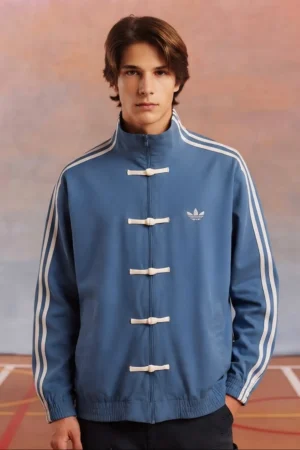Model Wearing Adidas CNY Jacket by The Drip Soul in blue Color and Showcase traditional knot button and Jacket detailing
